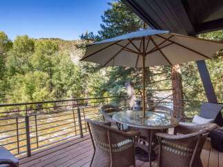 Enjoy breathtaking views from this stunning property overlooking a flowing river.