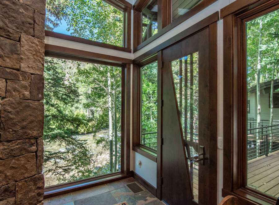 This stunning property boasts a unique architectural design, featuring expansive windows that frame breathtaking views of the surrounding natural beauty.