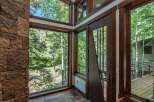 This stunning property boasts a unique architectural design, featuring expansive windows that frame breathtaking views of the surrounding natural beauty.