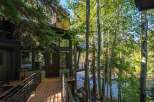 Nestled amidst lush greenery and overlooking a serene river, this stunning property offers a tranquil retreat.