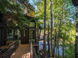 Nestled amidst lush greenery and overlooking a serene river, this stunning property offers a tranquil retreat.
