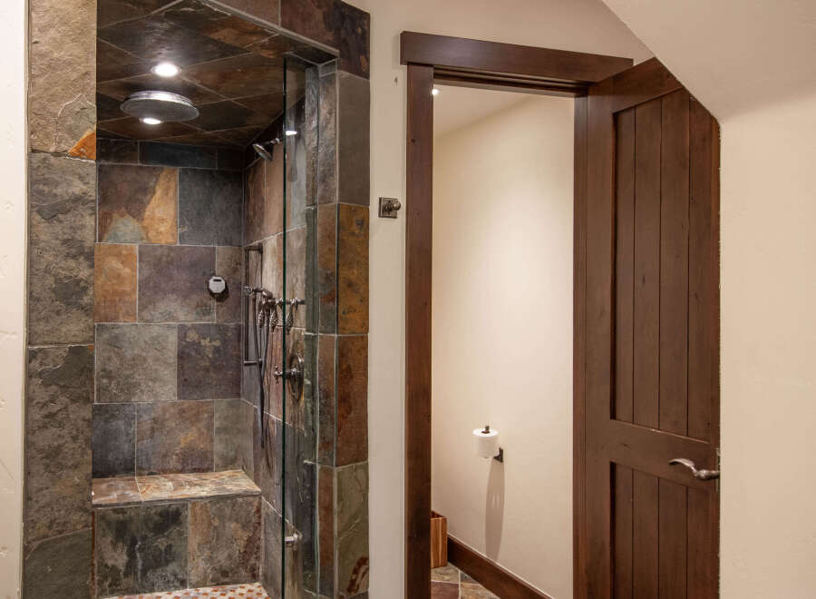 Step into luxury with this stunning bathroom featuring a custom tiled shower.