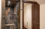 Step into luxury with this stunning bathroom featuring a custom tiled shower.