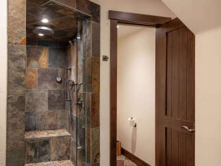 Step into luxury with this stunning bathroom featuring a custom tiled shower.