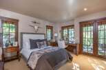 Experience luxury in this stunning bedroom featuring a cozy bed adorned with plush pillows and a faux fur throw.