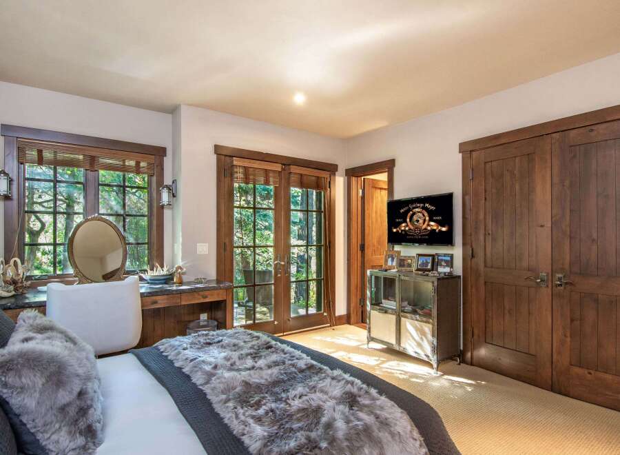 This luxurious bedroom boasts a serene ambiance with its plush bedding and elegant decor.