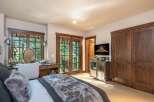 This luxurious bedroom boasts a serene ambiance with its plush bedding and elegant decor.