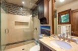 Step into luxury with this stunning bathroom featuring a modern glass shower and elegant vanity.
