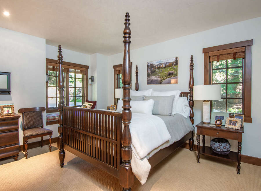 Step into luxury with this stunning bedroom featuring a grand four-poster bed as the centerpiece.