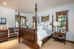 Step into luxury with this stunning bedroom featuring a grand four-poster bed as the centerpiece.
