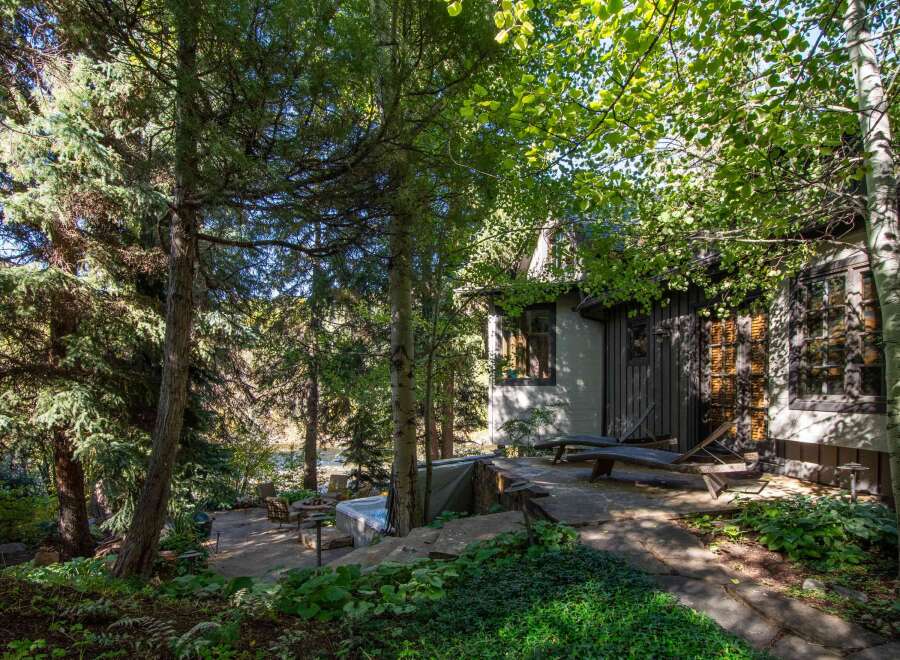 Escape to your own private oasis with this stunning property! Nestled amidst lush greenery and towering trees, this home offers a tranquil retreat.