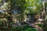 Escape to your own private oasis with this stunning property! Nestled amidst lush greenery and towering trees, this home offers a tranquil retreat.