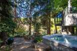 Escape to your own private oasis with this stunning property! Enjoy the tranquility of nature with a hot tub, outdoor seating, and a cozy fire pit.