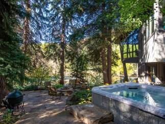 Escape to your own private oasis with this stunning property! Enjoy the tranquility of nature with a hot tub, outdoor seating, and a cozy fire pit.