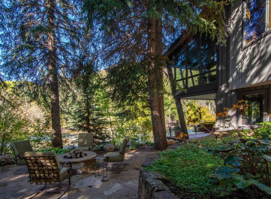 Escape to your dream home with this stunning property! Enjoy the tranquility of nature with a cozy outdoor seating area, perfect for relaxation.