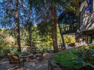Escape to your dream home with this stunning property! Enjoy the tranquility of nature with a cozy outdoor seating area, perfect for relaxation.