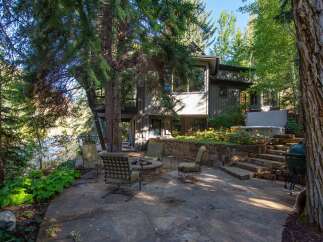 Nestled in a serene natural setting, this property offers a unique blend of comfort and outdoor living.