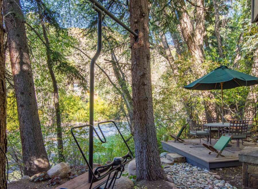 Enjoy the tranquility of nature with this stunning property featuring a private deck and outdoor seating area.