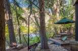 Enjoy the tranquility of nature with this stunning property featuring a private deck and outdoor seating area.