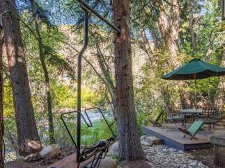 Enjoy the tranquility of nature with this stunning property featuring a private deck and outdoor seating area.