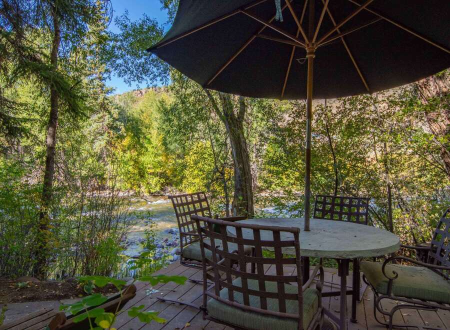 Enjoy the tranquility of nature from this stunning outdoor dining area.