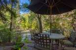 Enjoy the tranquility of nature from this stunning outdoor dining area.
