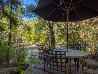 Enjoy the tranquility of nature from this stunning outdoor dining area.