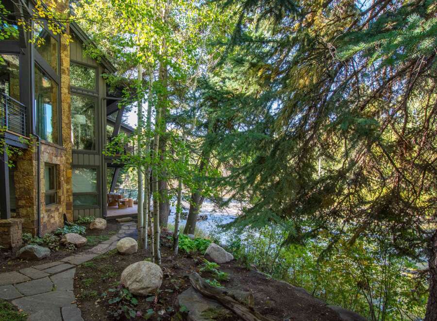 Nestled amidst lush greenery, this stunning property boasts a harmonious blend of nature and modern architecture.