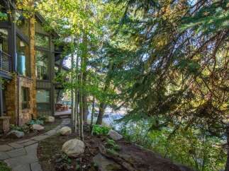 Nestled amidst lush greenery, this stunning property boasts a harmonious blend of nature and modern architecture.