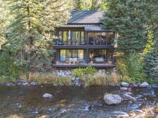 Nestled amidst lush greenery, this stunning property offers a serene retreat with breathtaking river views.