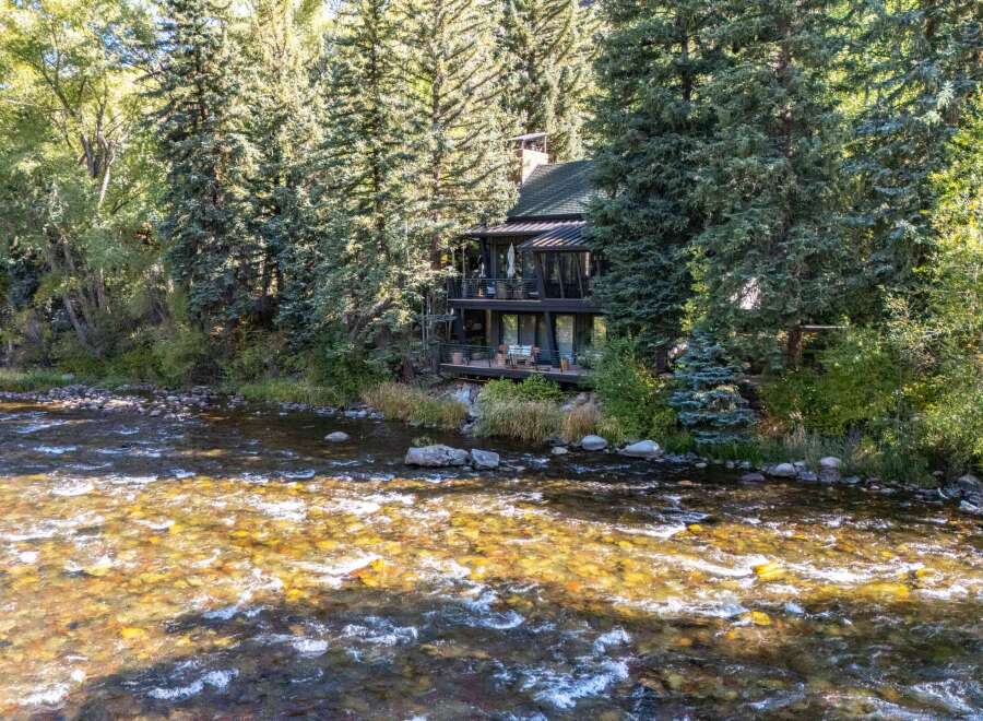 Nestled amidst lush greenery, this stunning property offers a serene retreat with direct river access.