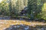 Nestled amidst lush greenery, this stunning property offers a serene retreat with direct river access.