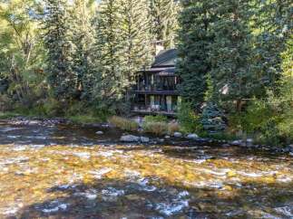 Nestled amidst lush greenery, this stunning property offers a serene retreat with direct river access.