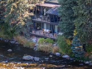 Nestled along a serene river, this stunning property offers a unique blend of natural beauty and modern design.