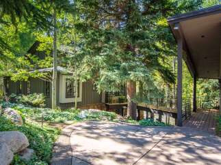 Nestled amidst lush greenery, this stunning property offers a serene retreat.