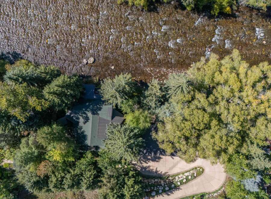 Nestled along a serene river, this property offers a unique blend of natural beauty and modern living.