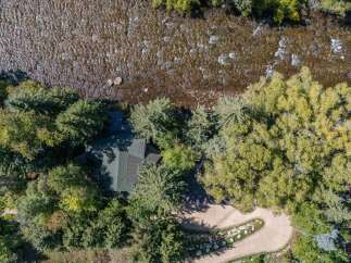 Nestled along a serene river, this property offers a unique blend of natural beauty and modern living.