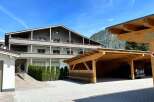 Discover a charming property featuring a stylish wooden carport, perfect for protecting your vehicles.