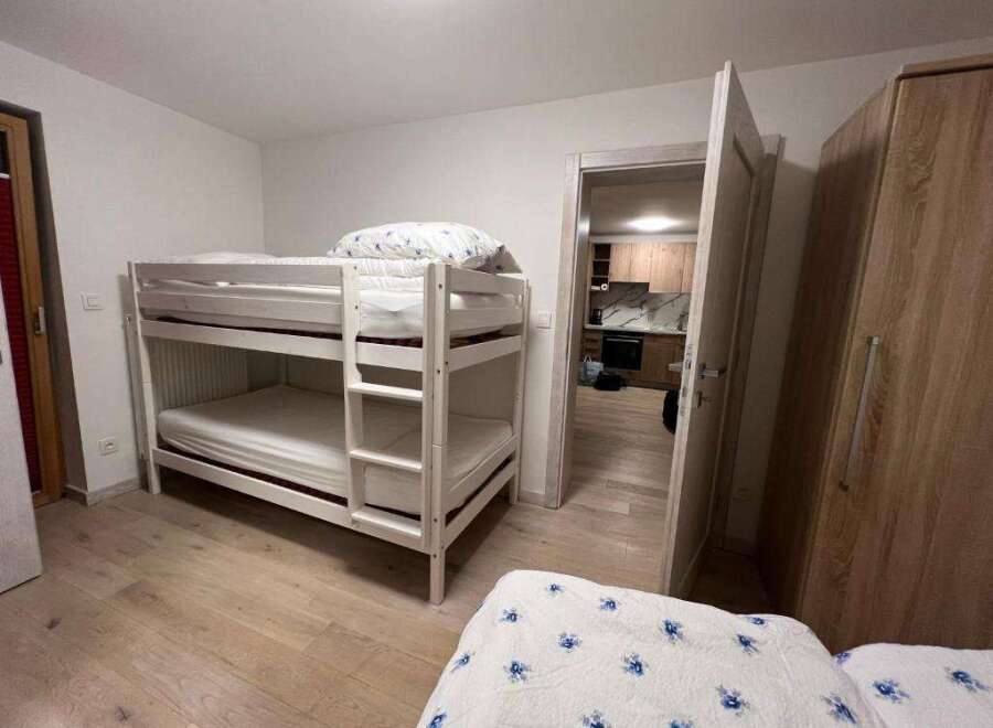 This cozy bedroom features a bunk bed, perfect for accommodating guests or family members.