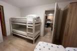 This cozy bedroom features a bunk bed, perfect for accommodating guests or family members.