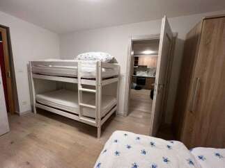 This cozy bedroom features a bunk bed, perfect for accommodating guests or family members.