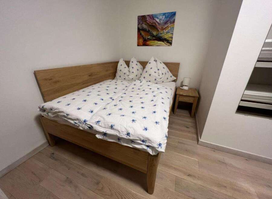 This cozy bedroom features a comfortable bed with a stylish duvet cover and pillows.