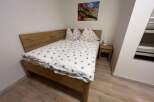 This cozy bedroom features a comfortable bed with a stylish duvet cover and pillows.