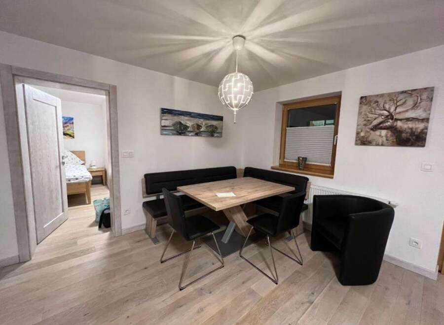 This charming dining area features a modern design with a stylish table and seating arrangement.