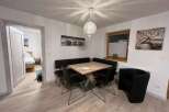 This charming dining area features a modern design with a stylish table and seating arrangement.
