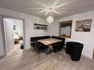 This charming dining area features a modern design with a stylish table and seating arrangement.