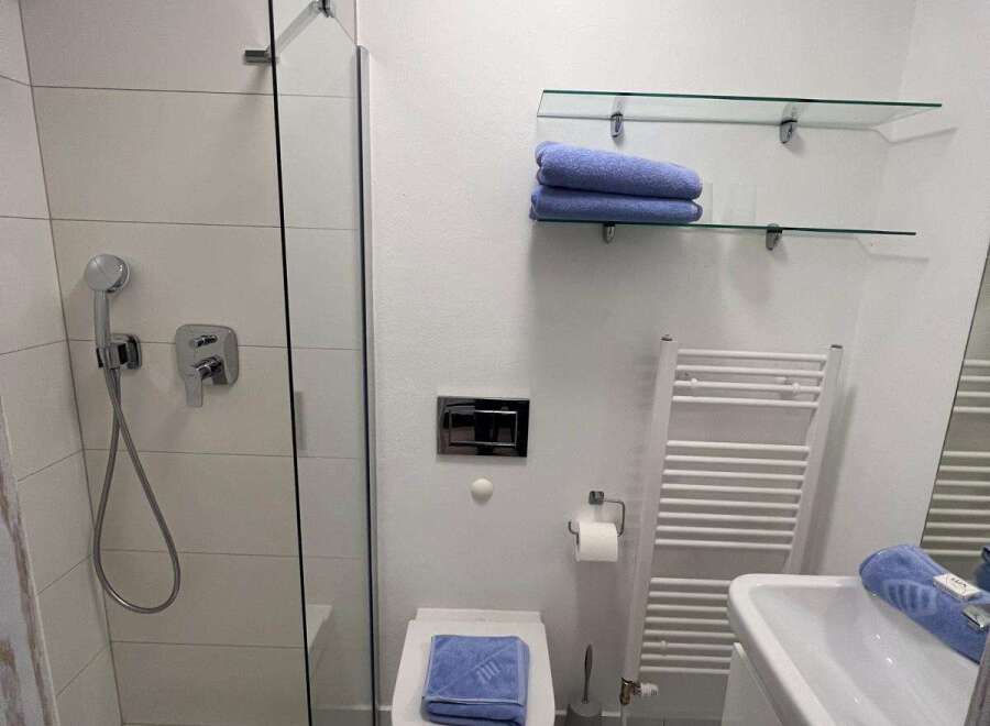Step into a modern bathroom oasis! This space features a sleek glass shower enclosure, perfect for a refreshing start to your day.