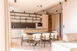 Experience modern luxury in this stunning property, featuring a sleek kitchen with stainless steel appliances and ample counter space.