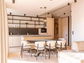 Experience modern luxury in this stunning property, featuring a sleek kitchen with stainless steel appliances and ample counter space.