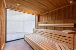 Step into relaxation with this stunning sauna, featuring warm wooden interiors and a spacious design.